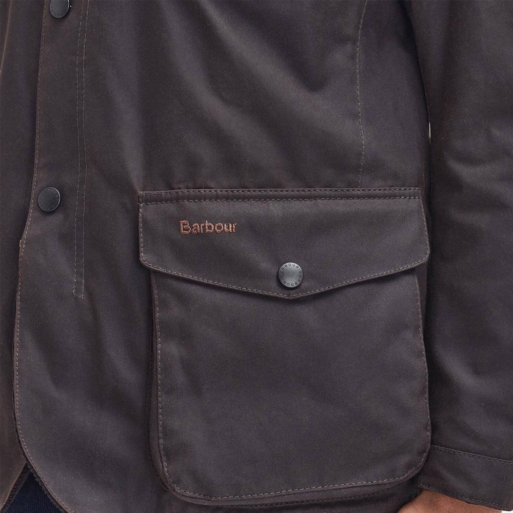 Barbour wax jacket front pocket with Barbour logo patch and snap-button flap