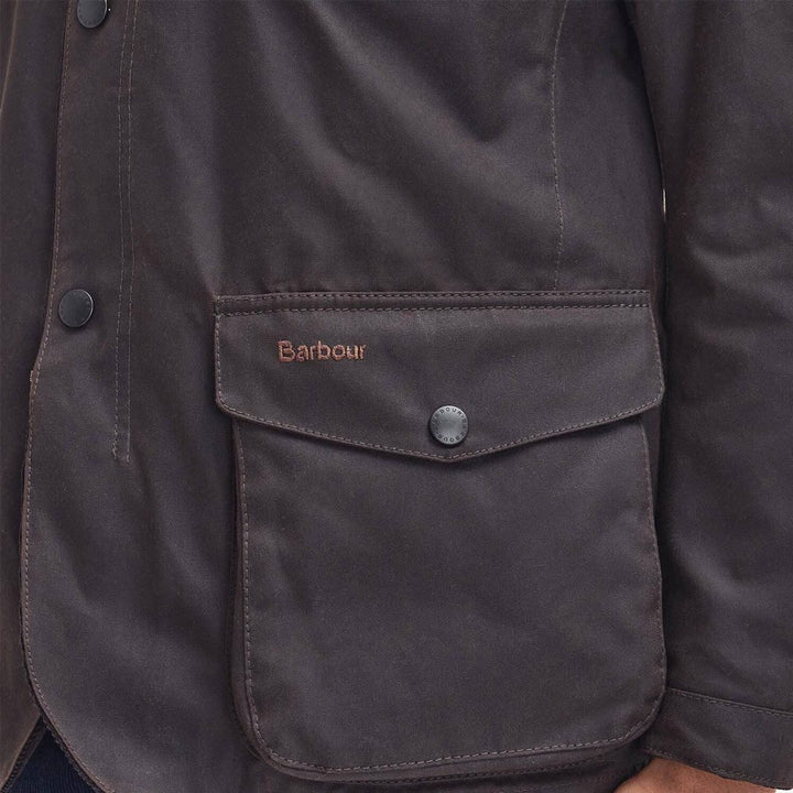 Barbour wax jacket front pocket with Barbour logo patch and snap-button flap