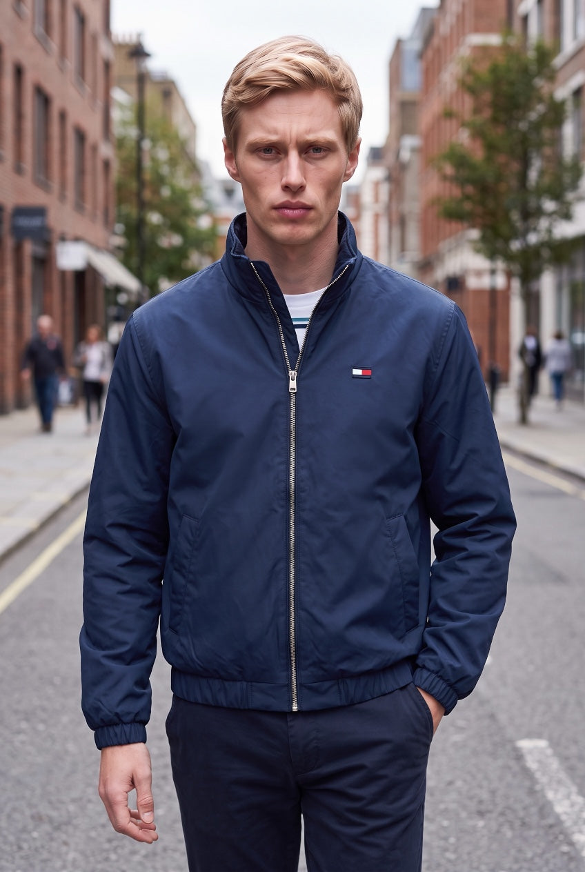 TOMMY JEANS padded jacket in dark blue with full zip front and small chest flag patch