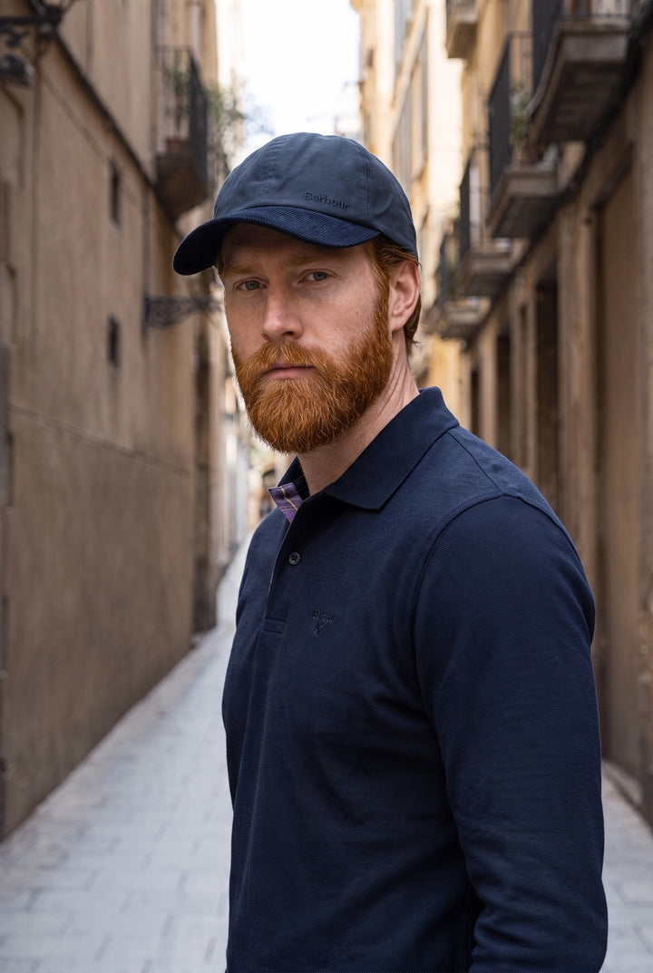 Navy Barbour Ashby cap worn by a man, curved brim and front logo