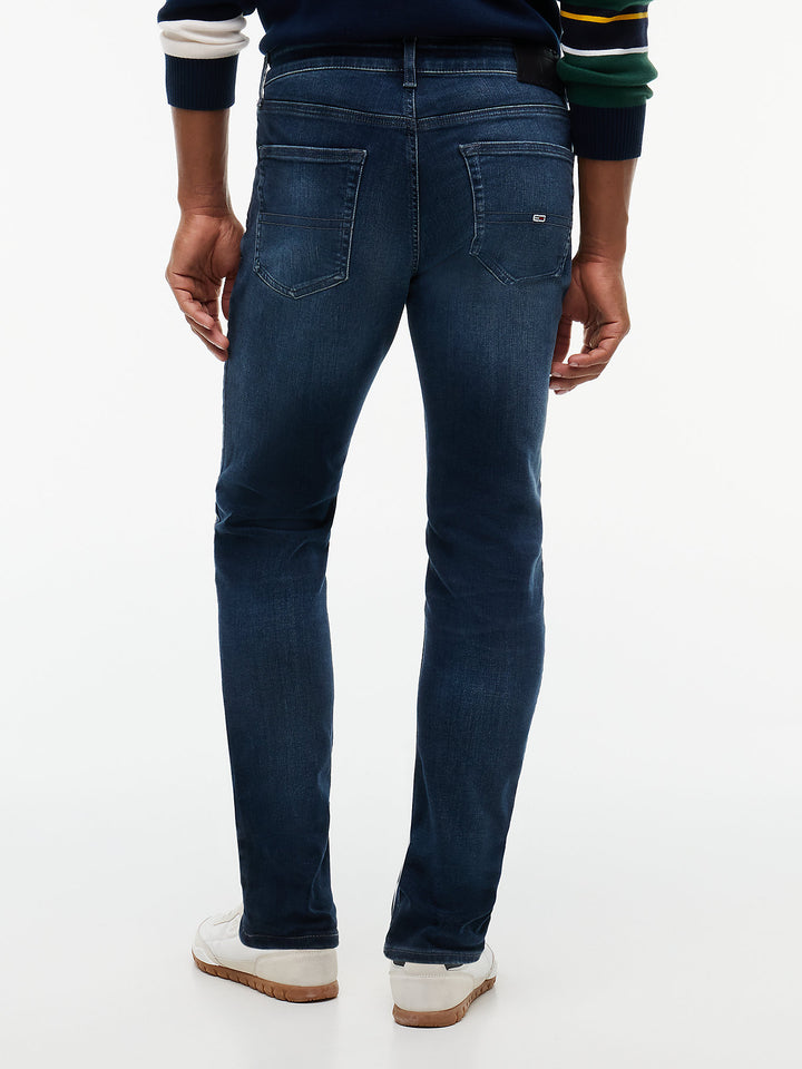 Dark blue slim-fit denim jeans with back pockets and stitched pocket detailing