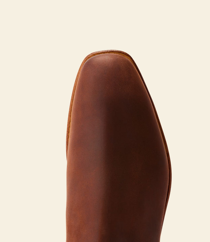 Brown boot upper close-up, smooth suede surface and rounded toe