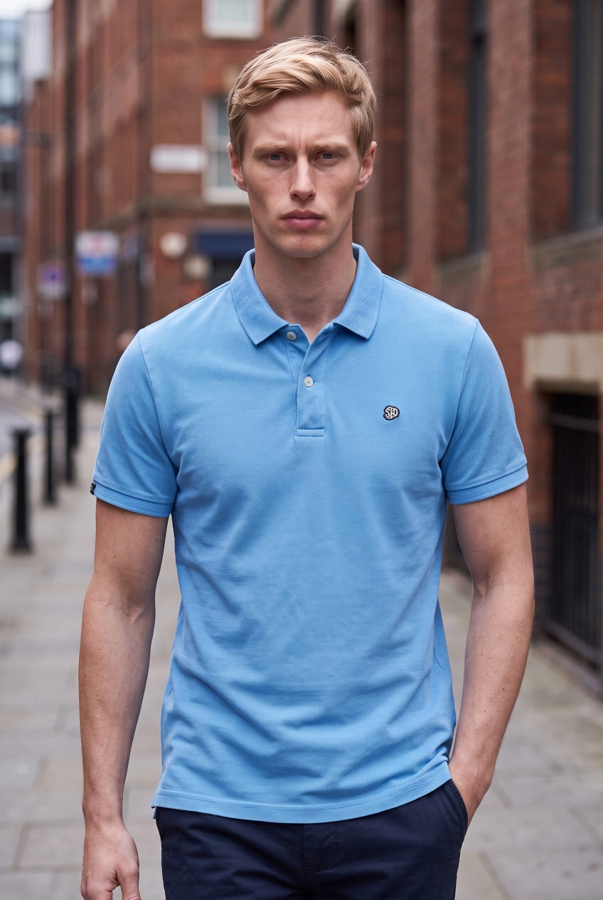 Light blue vintage destroy polo shirt with short sleeves, button placket, chest logo