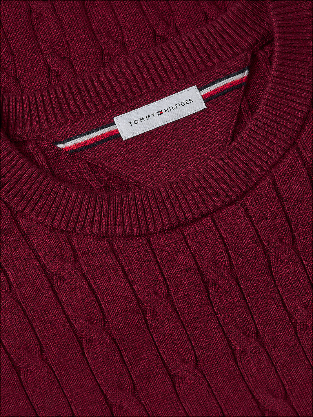 Burgundy knit crewneck sweater with TOMMY HILFIGER tag near neckline