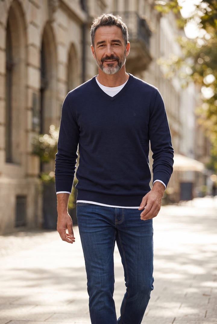 Navy cotton V-neck sweater worn with blue jeans, long sleeves
