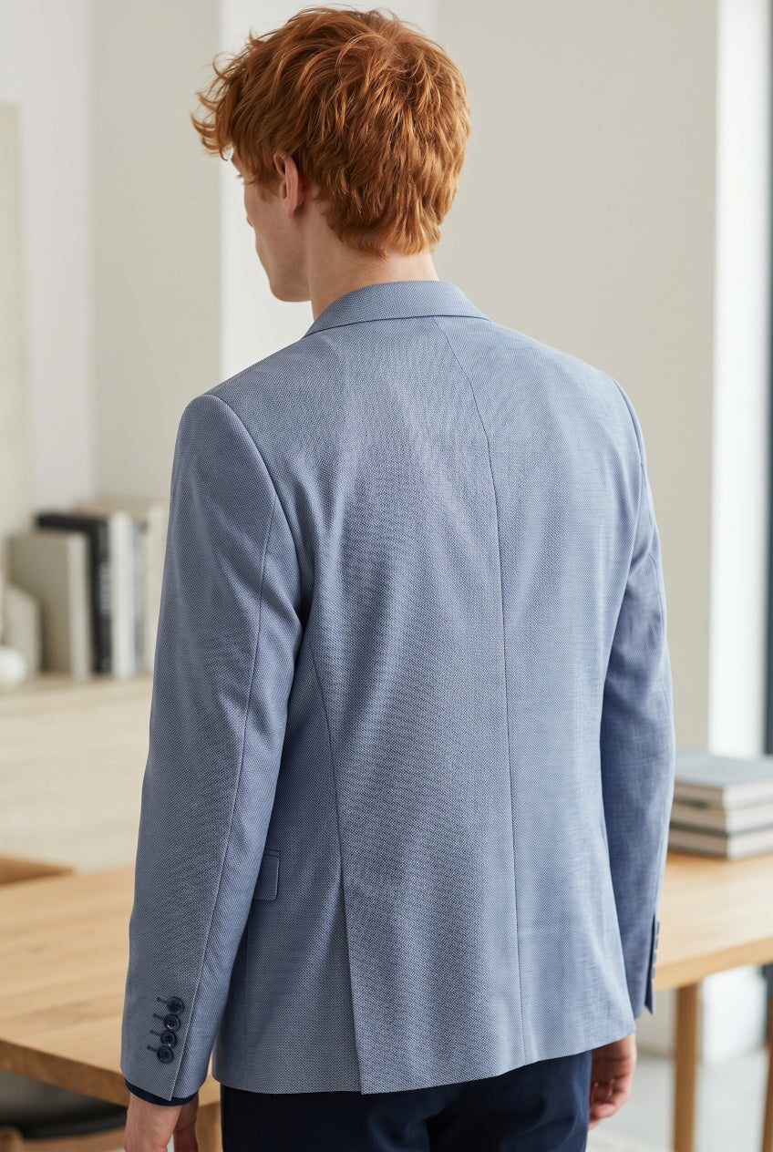 Light blue blazer back view with notched collar and rear vent