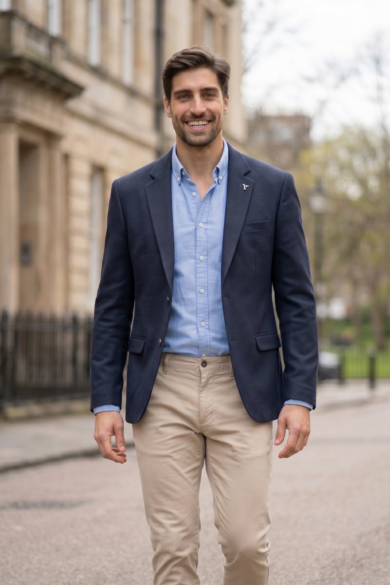 Navy blazer with notch lapels, welt pockets, and button-front closure