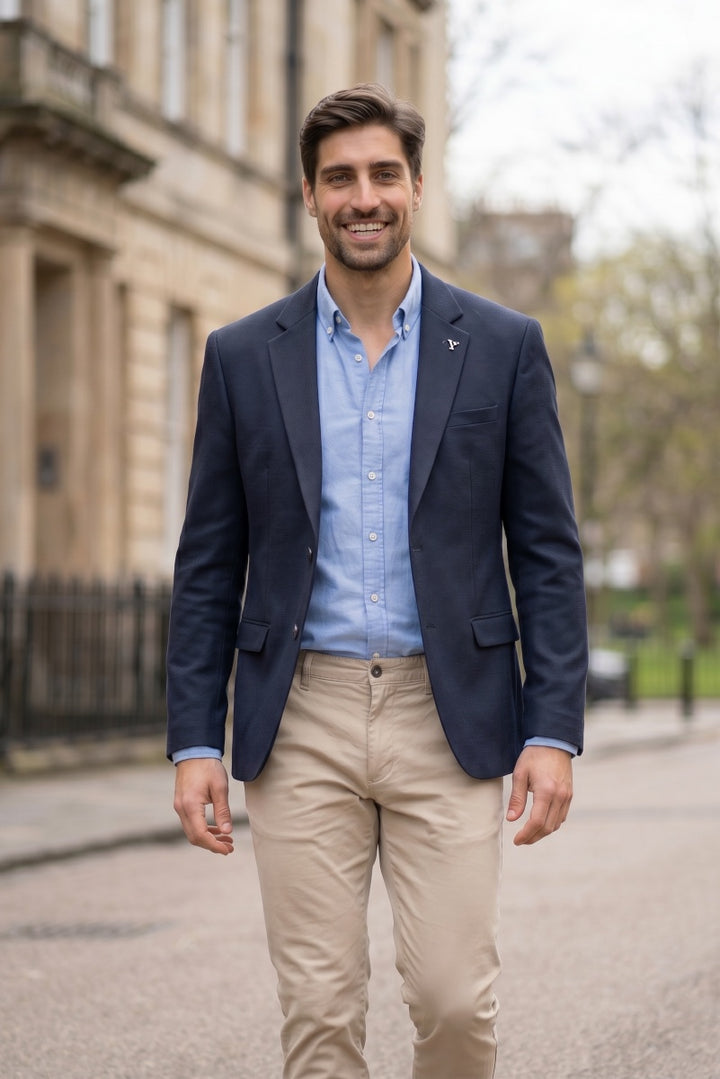 Navy blazer with notch lapels, welt pockets, and button-front closure