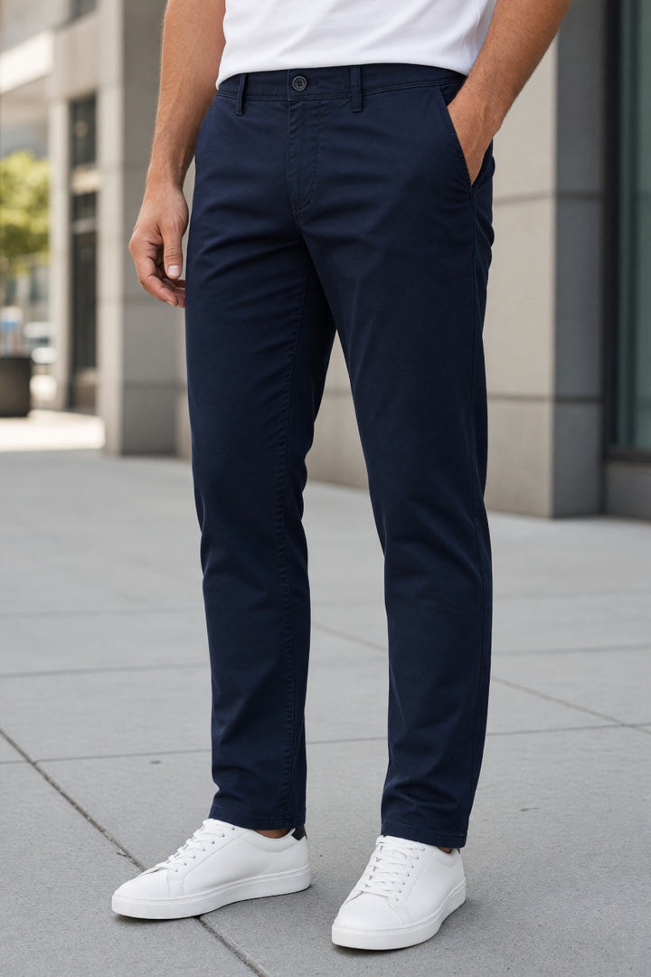 Navy stretch tapered chino pants with button fly, belt loops, and front pockets