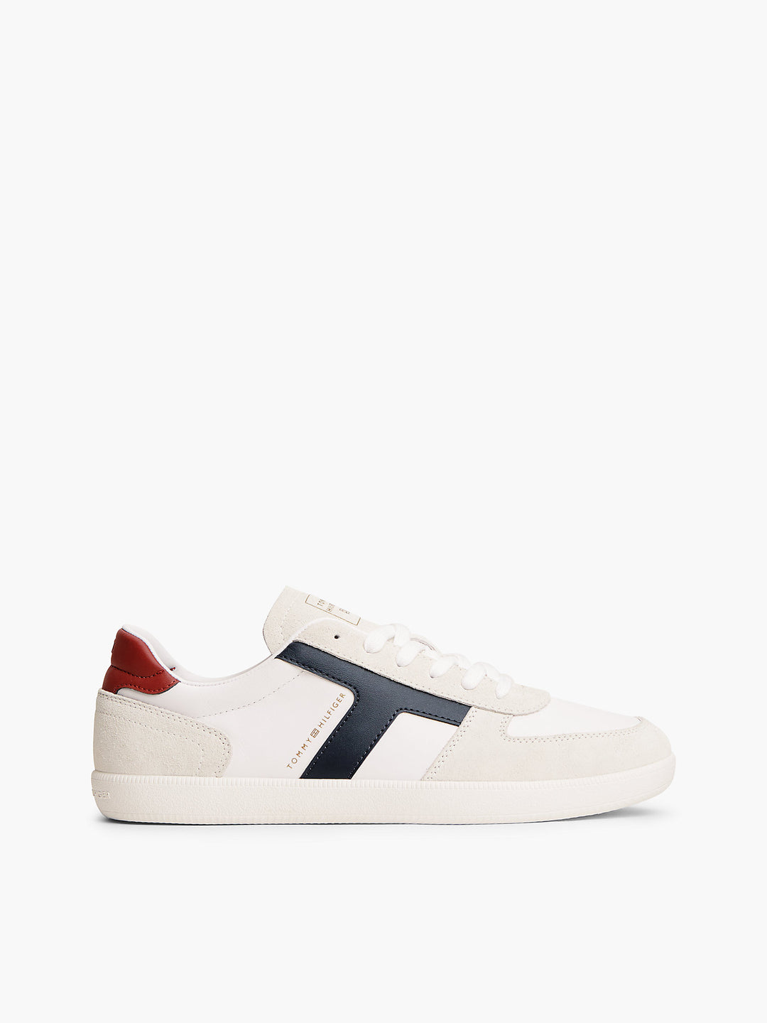 Cream and white low-top sneakers with navy side stripe and red heel tab