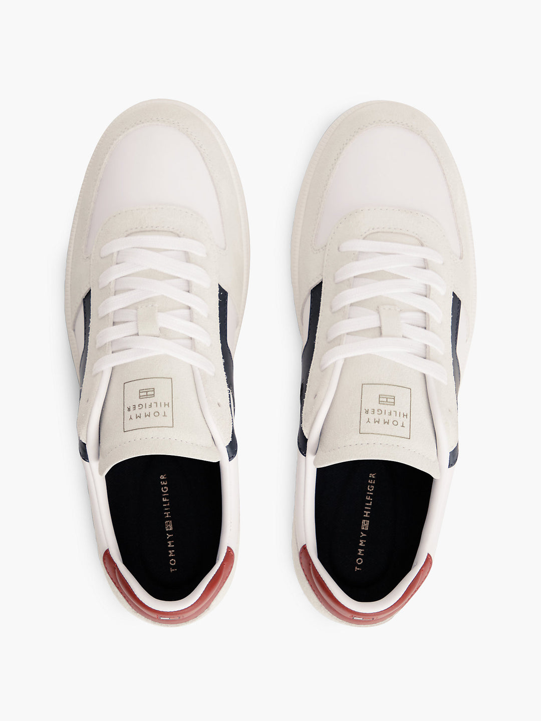 Pair of white sneakers with white laces, navy heel accents, top view
