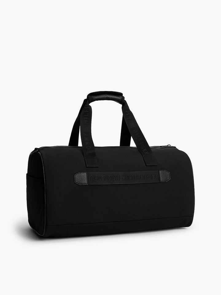 Black duffle bag with wide front strap panel and top carry handles