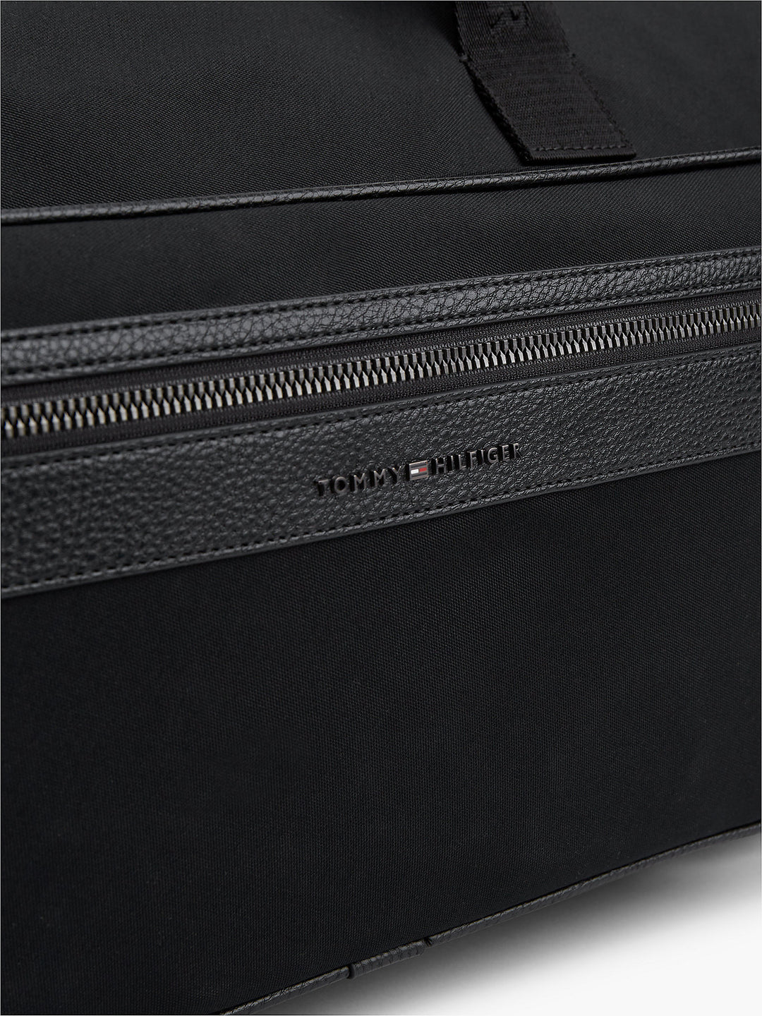 Black textured duffle bag with TOMMY HILFIGER logo and zippered top opening