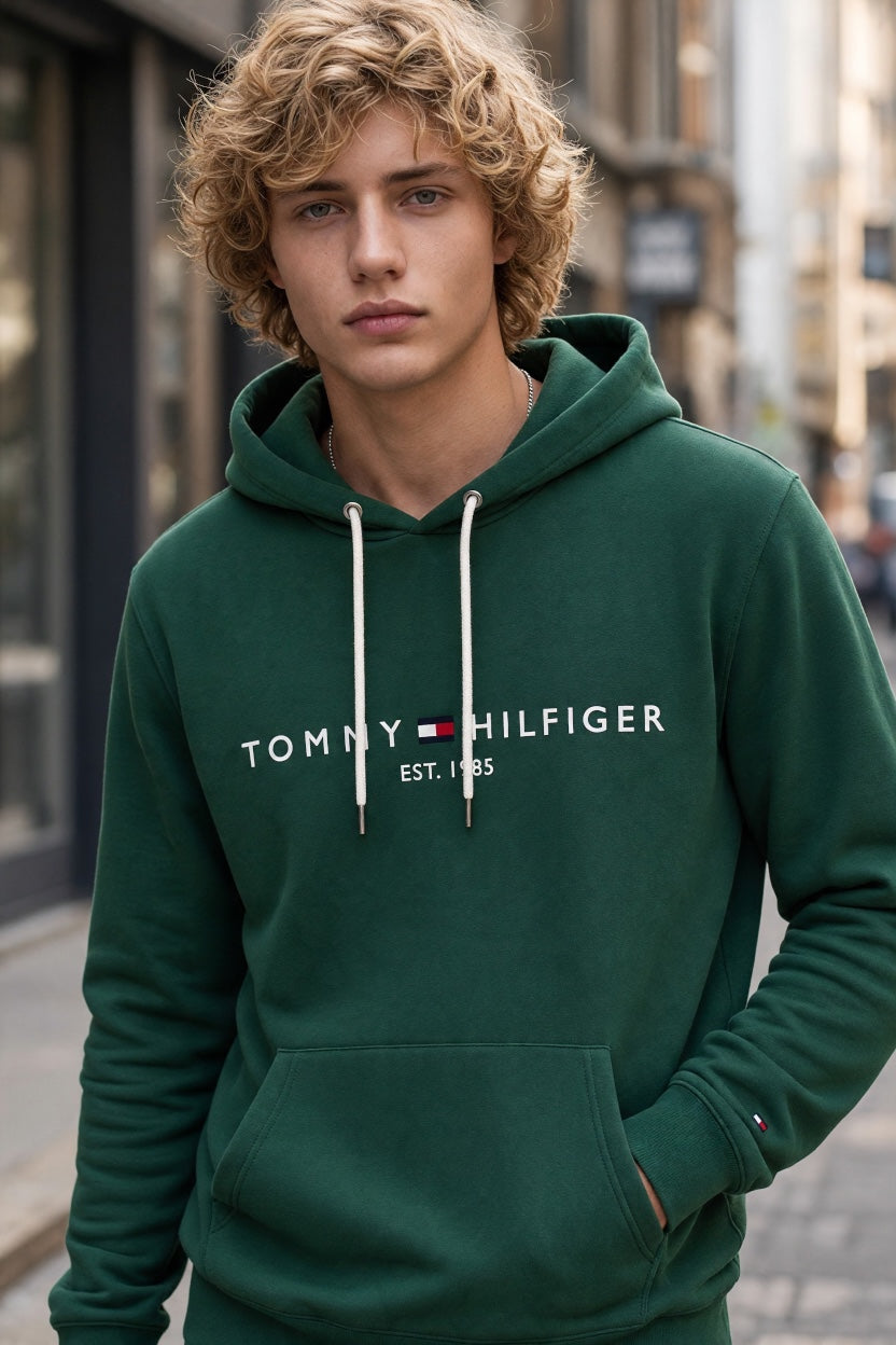 Green Tommy Hilfiger logo hoodie with hood, white drawstrings, and front pouch pocket