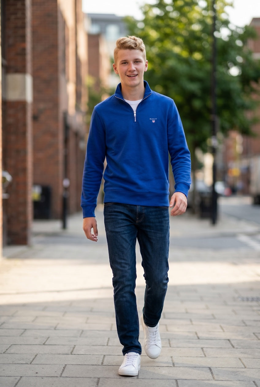 GANT blue half-zip sweatshirt worn with jeans, chest logo and ribbed cuffs