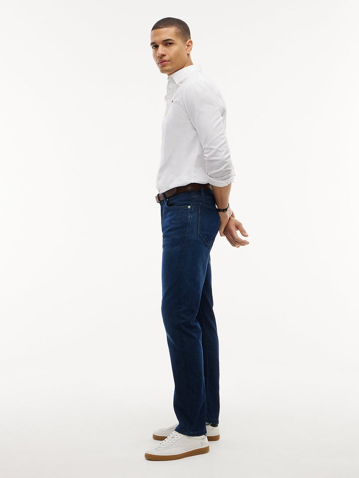 Dark blue slim-straight jeans on model, straight leg with belt loops
