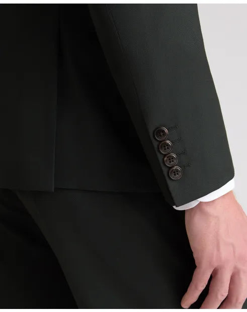 Dark green suit jacket sleeve cuff with four-button closure and white shirt cuff