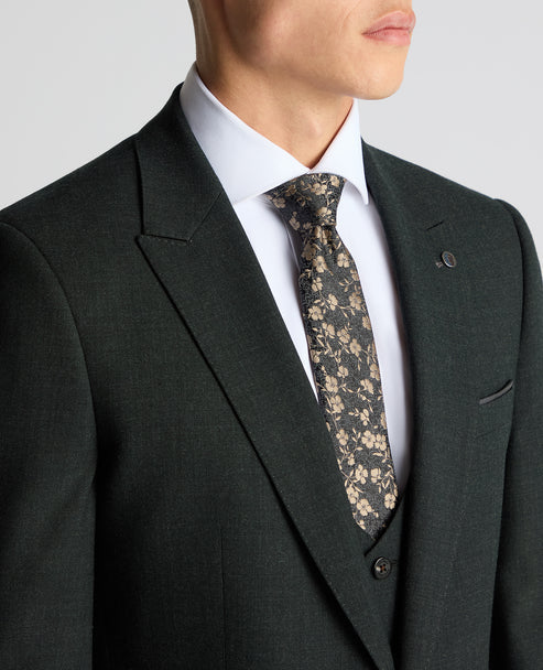 Dark green suit jacket with notch lapels, breast pocket, and patterned tie