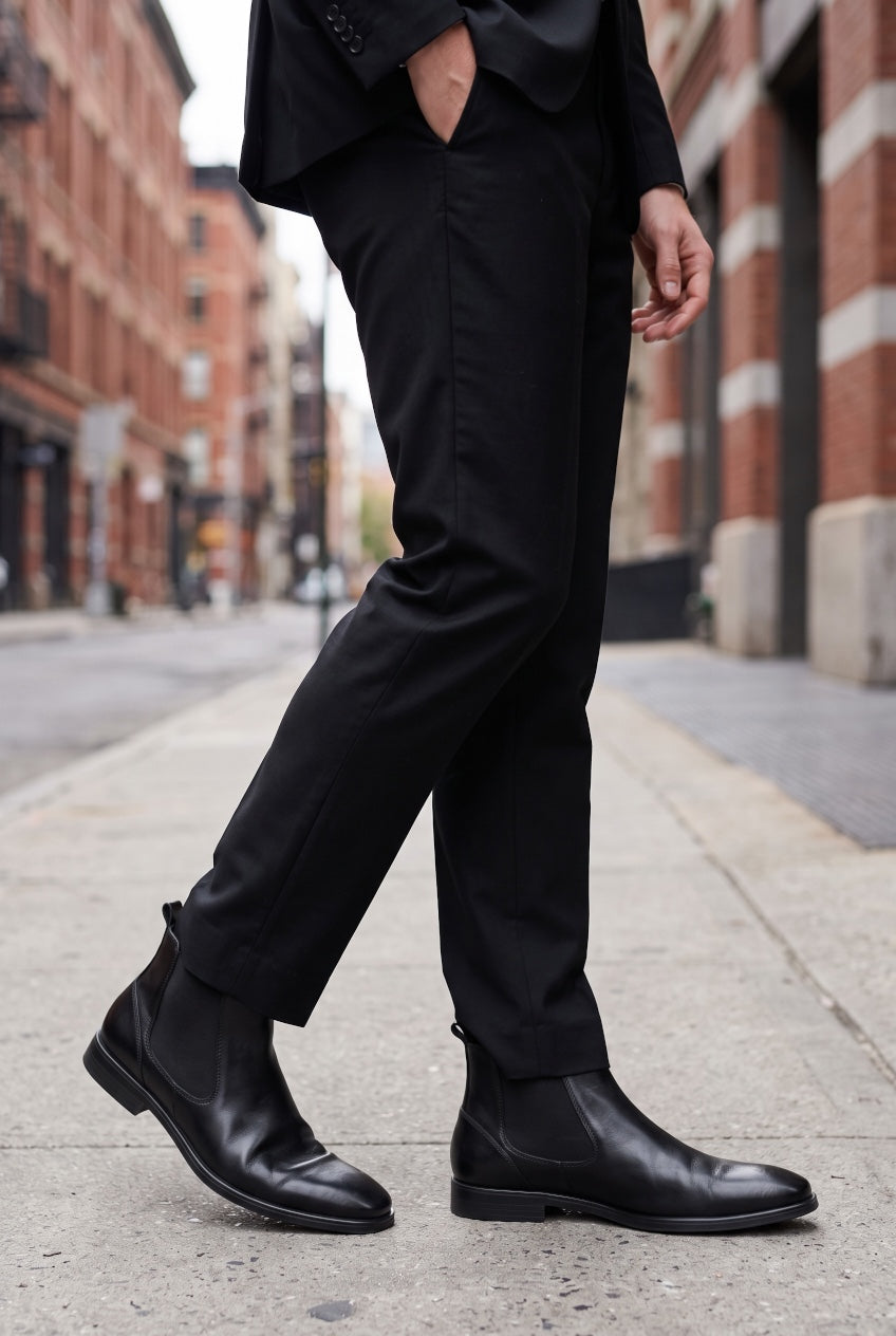 Black chelsea boots with elastic sides worn with dark trousers, low block heel