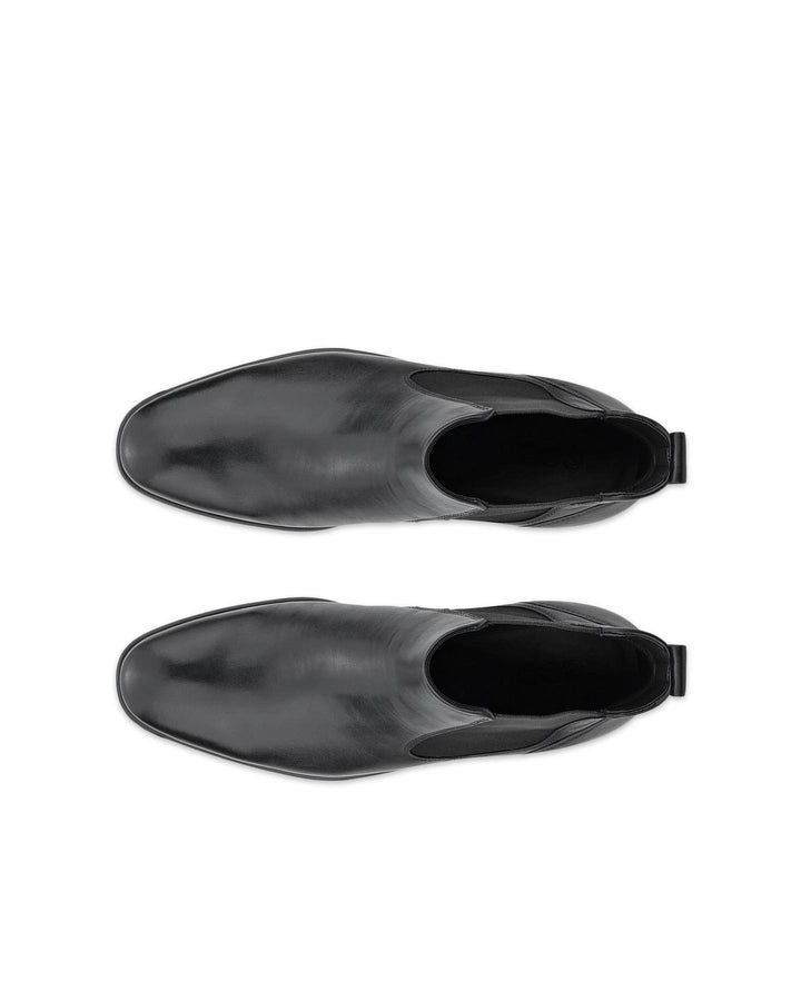 Black chelsea boots shown from toe and heel, elastic opening at side