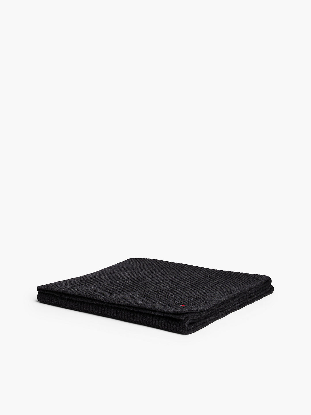 Folded dark knit scarf, ribbed texture with small flag logo
