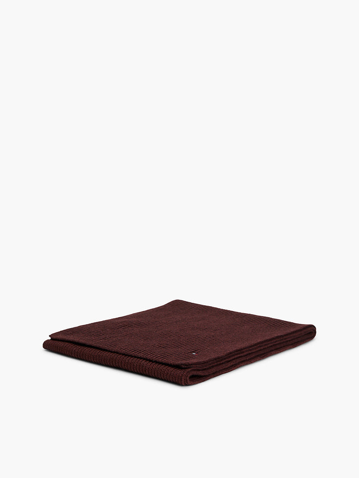 Folded burgundy ribbed scarf with subtle flag logo