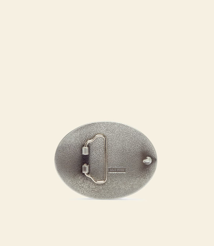 R.M. Williams gold logo buckle back, metal pin and clasp on dark backing