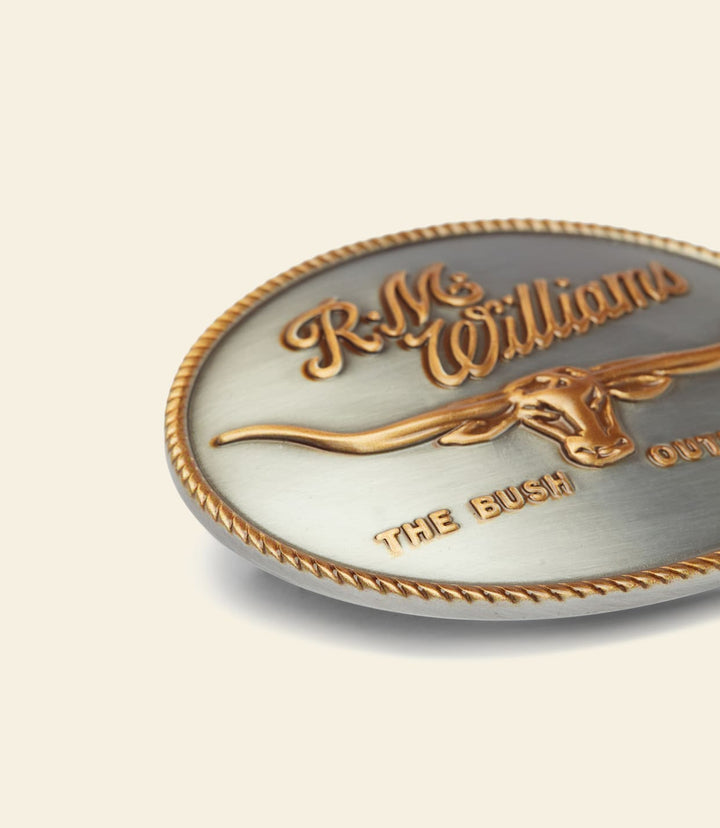 R.M. Williams logo buckle close-up, gold horse head and script lettering