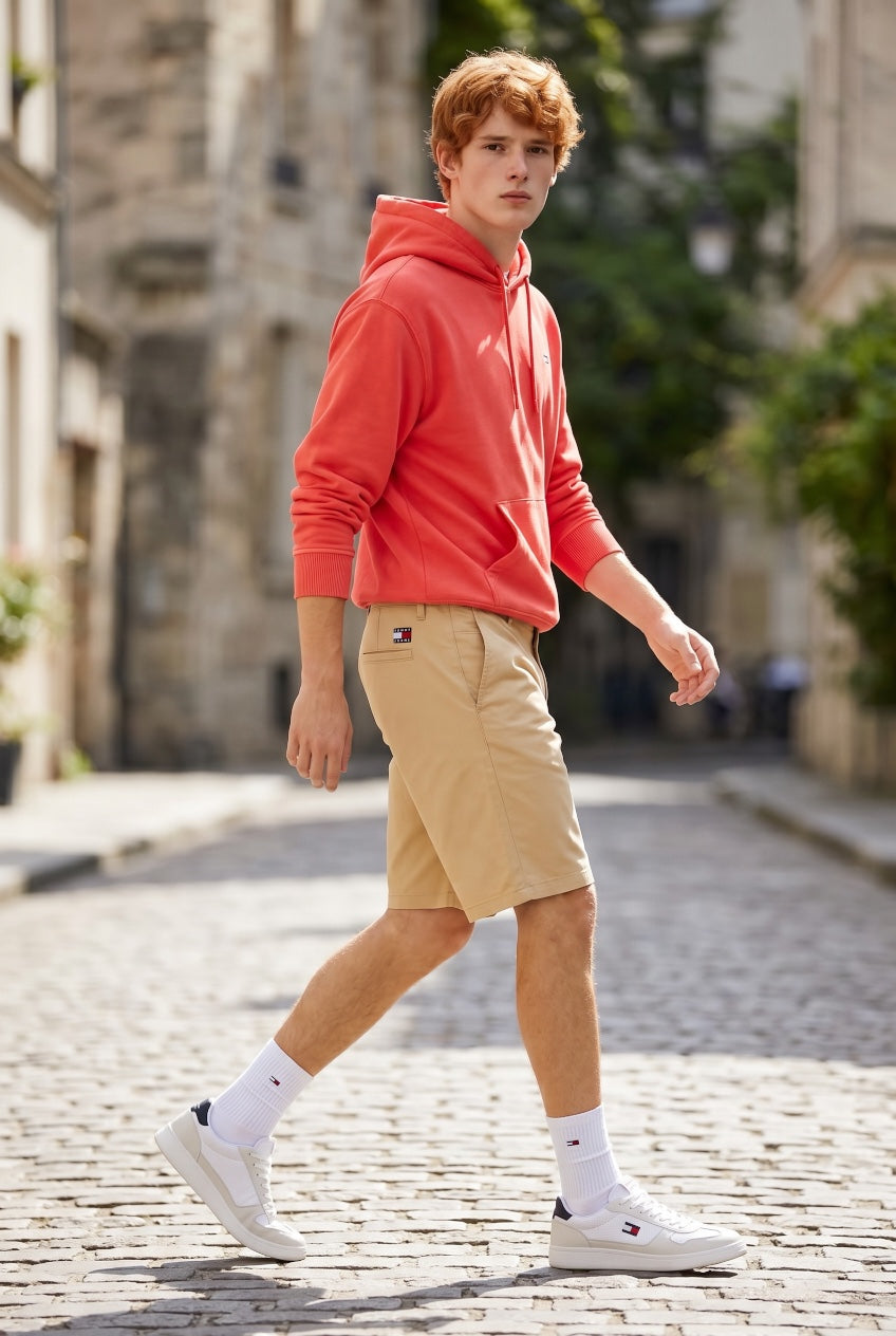 Tan shorts with front pockets, belt loops, and mid-thigh cuffed hem