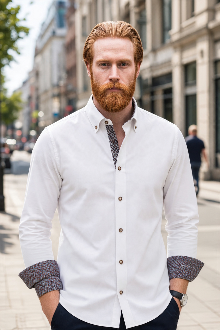 White dress shirt with button front, dark-trimmed collar and patterned cuffs