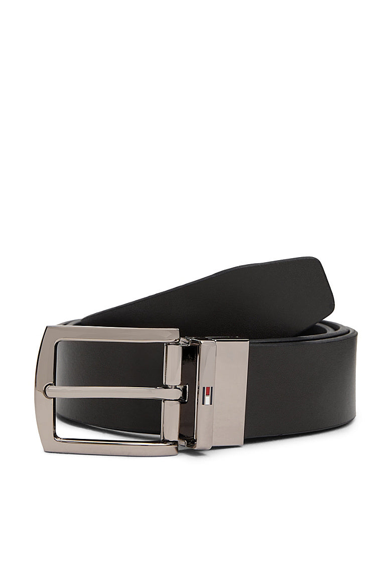 Reversible leather belt with silver buckle on black strap, flat front view