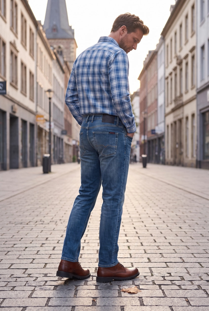Slim-straight blue jeans on model, rear view with back yoke and pockets