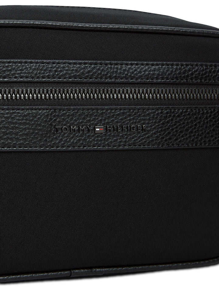 Black wash bag close-up with textured panel, TOMMY HILFIGER logo, and zip