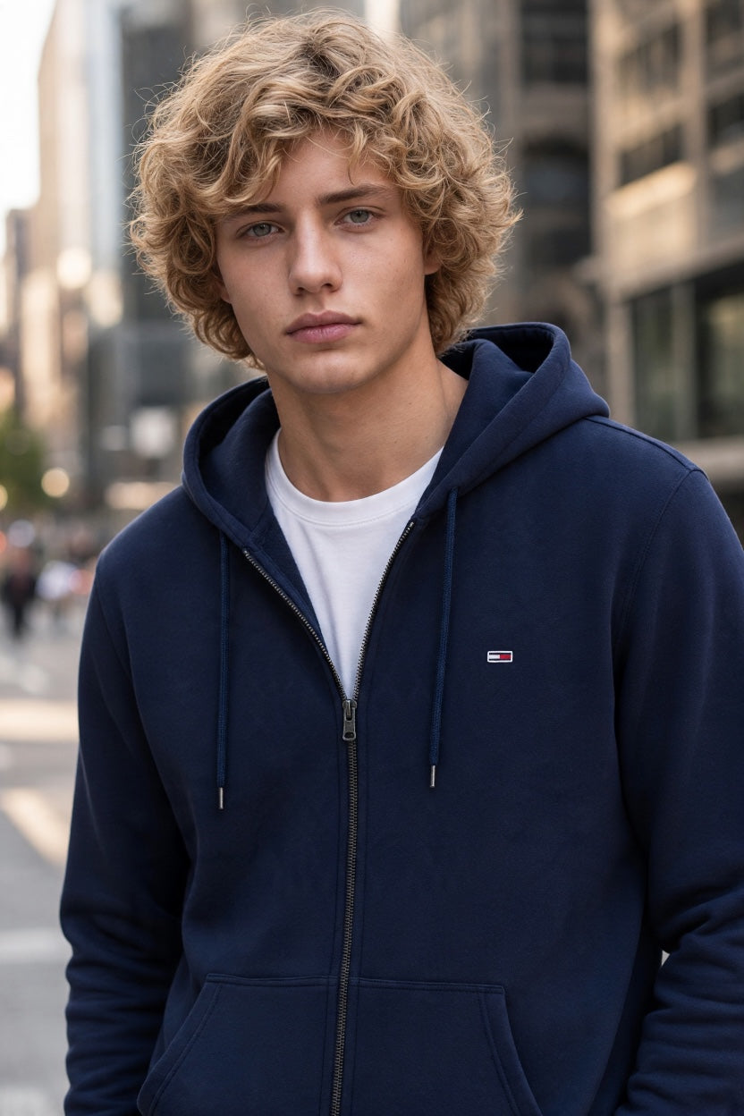Navy zip-up hoodie with hood and drawstrings, chest logo detail