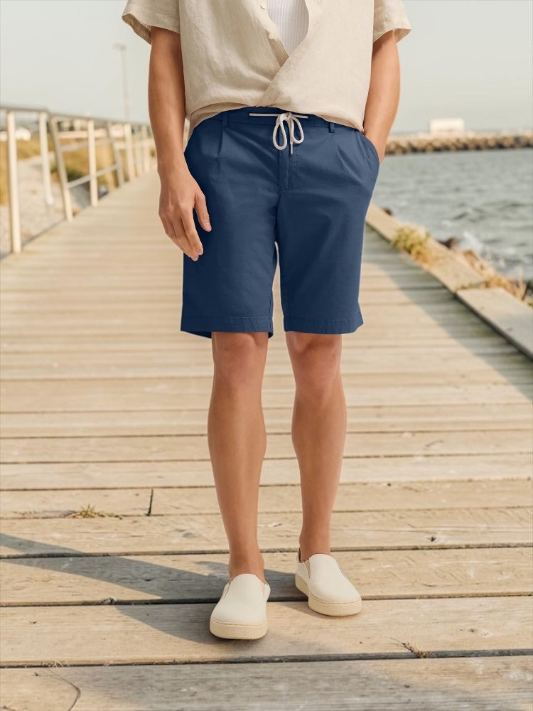 Blue linen-mix drawstring shorts with front pockets and knee-length hem